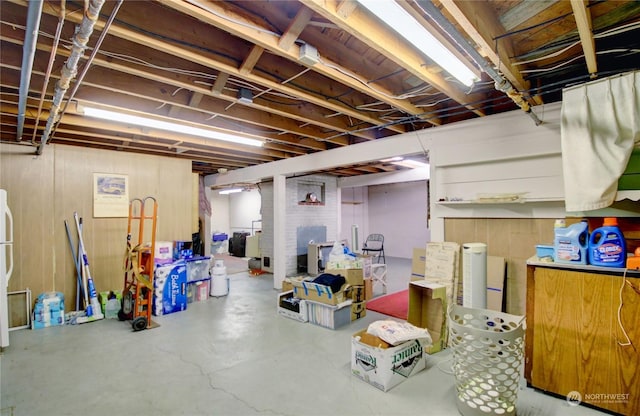 basement featuring wood walls