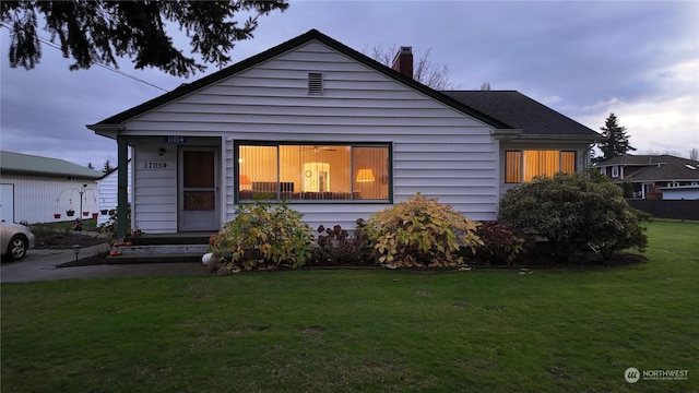 bungalow-style house featuring a front yard