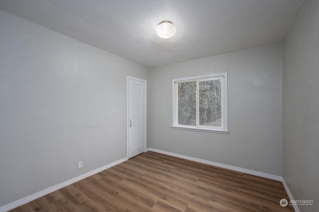 spare room featuring dark hardwood / wood-style flooring