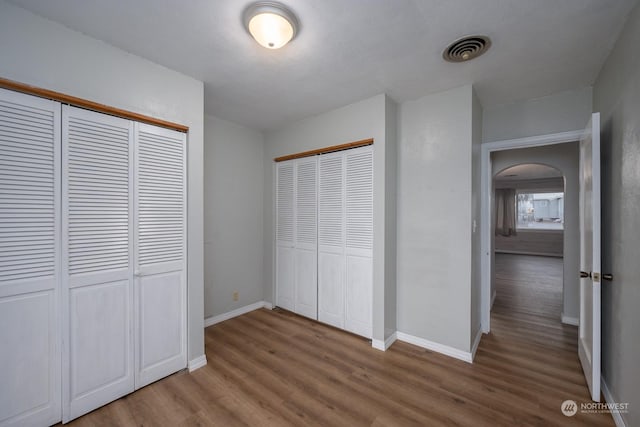 unfurnished bedroom featuring hardwood / wood-style flooring