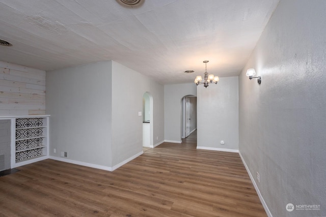 interior space featuring dark hardwood / wood-style flooring and a chandelier