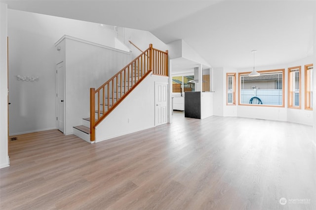 340 Brandi Ln, Wenatchee, WA 98801 - unfurnished living room with stairway, wood finished floors, baseboards, and lofted ceiling