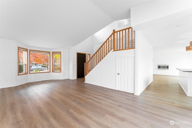 340 Brandi Ln, Wenatchee, WA 98801 - unfurnished living room with wood finished floors, stairway, and vaulted ceiling