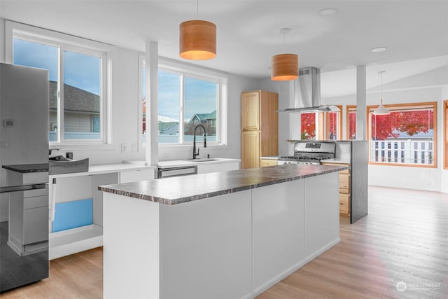 340 Brandi Ln, Wenatchee, WA 98801 - kitchen with island range hood, appliances with stainless steel finishes, a sink, light wood-type flooring, and pendant lighting