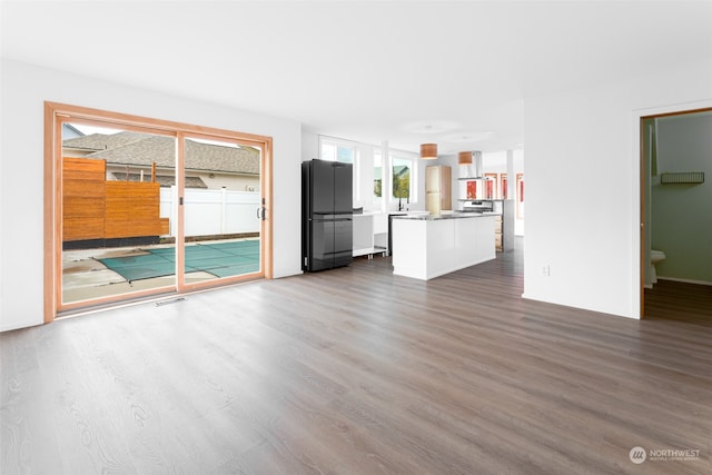 unfurnished living room featuring dark hardwood / wood-style floors