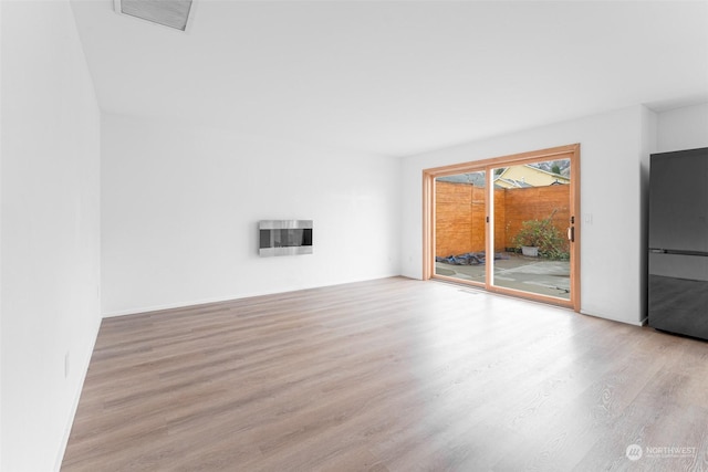 340 Brandi Ln, Wenatchee, WA 98801 - unfurnished living room featuring wood finished floors and heating unit