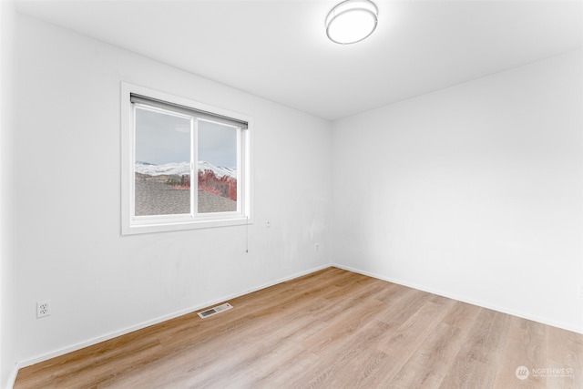 spare room featuring light hardwood / wood-style floors