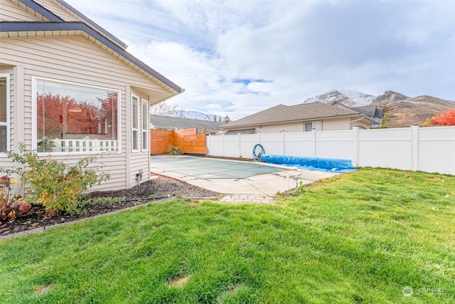 view of yard featuring a mountain view and a patio area