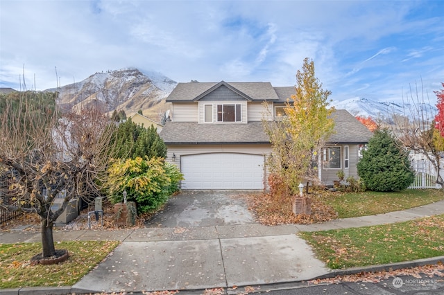 view of front of home with a mountain view and a garage