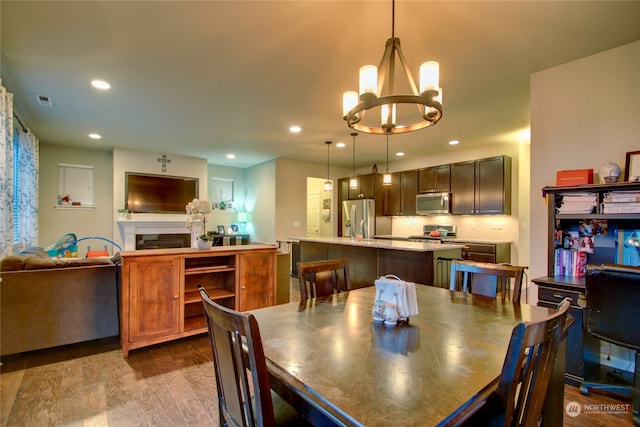 dining area featuring light wood-type flooring and a chandelier