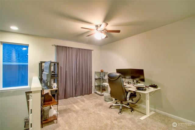 home office with light carpet and ceiling fan