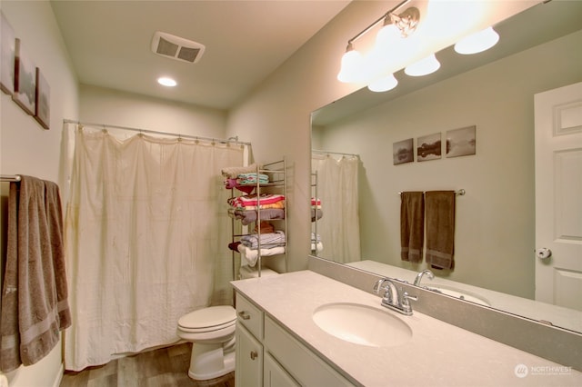 bathroom with a shower with curtain, toilet, vanity, and hardwood / wood-style flooring