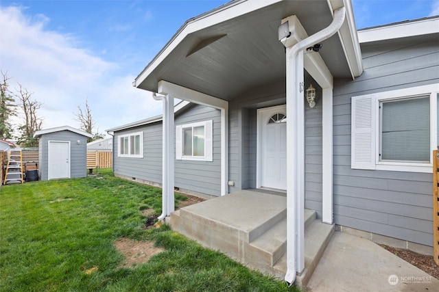 view of exterior entry with a lawn