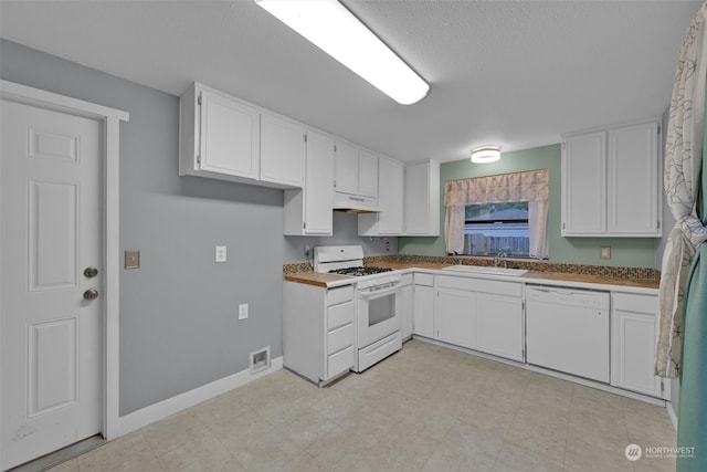 kitchen with sink, white cabinets, exhaust hood, and white appliances