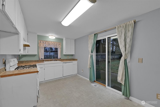 kitchen featuring white cabinets, white appliances, wooden counters, and sink