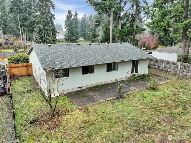 back of house with a lawn and a patio