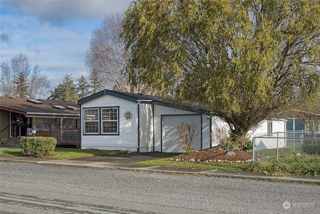 view of front of home with a garage and a deck