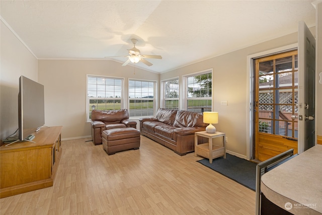 living room with ceiling fan, plenty of natural light, light hardwood / wood-style floors, and vaulted ceiling