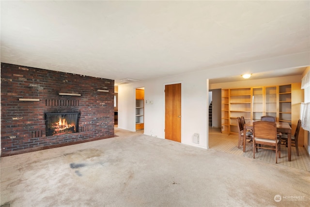 carpeted living room with a brick fireplace