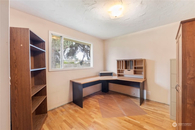 office featuring wood-type flooring and a textured ceiling