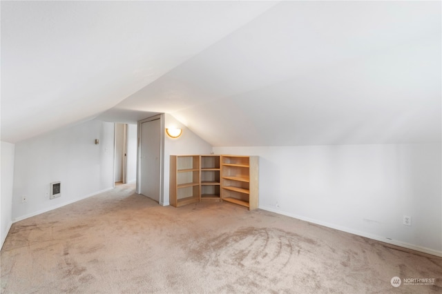 additional living space with light carpet and lofted ceiling