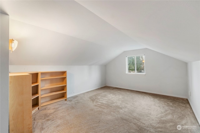 bonus room with carpet and lofted ceiling