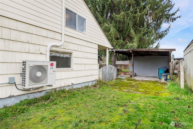 view of side of property featuring a lawn and ac unit