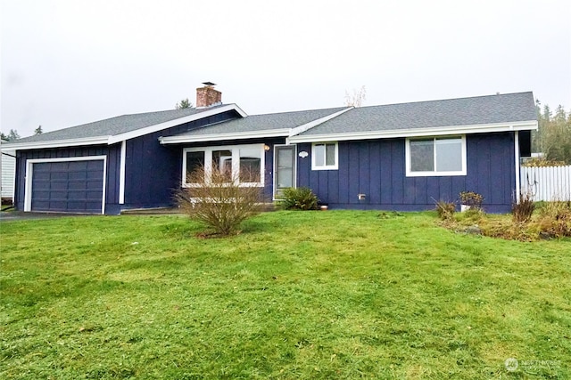 single story home with a garage and a front lawn