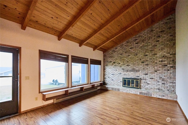 unfurnished living room featuring hardwood / wood-style floors, vaulted ceiling with beams, a fireplace, baseboard heating, and wood ceiling