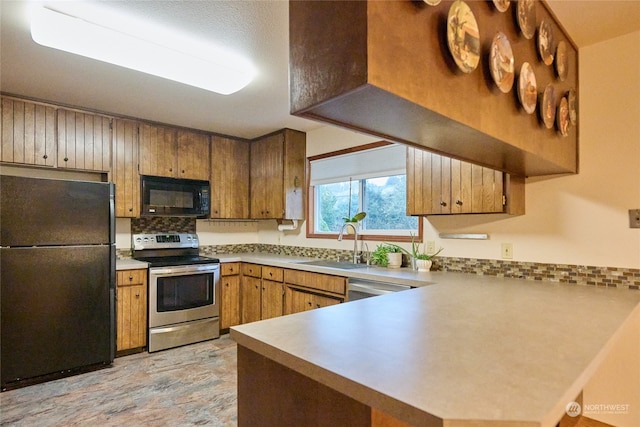 kitchen with black appliances, kitchen peninsula, and sink