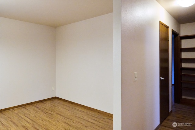 unfurnished room featuring hardwood / wood-style flooring