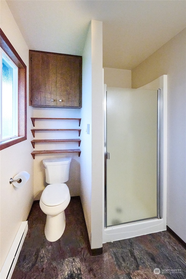 bathroom with toilet, a shower with door, and a baseboard radiator