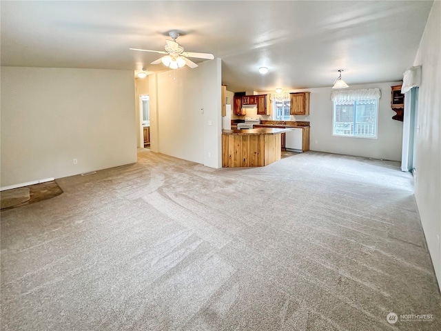 unfurnished living room with ceiling fan and light colored carpet