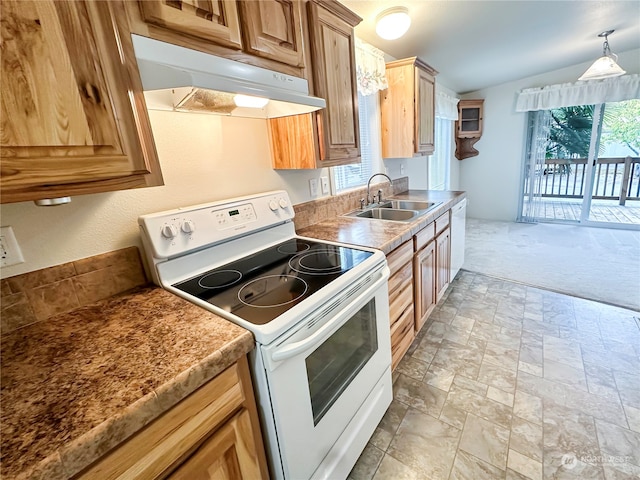 kitchen with electric range, sink, pendant lighting, light colored carpet, and vaulted ceiling