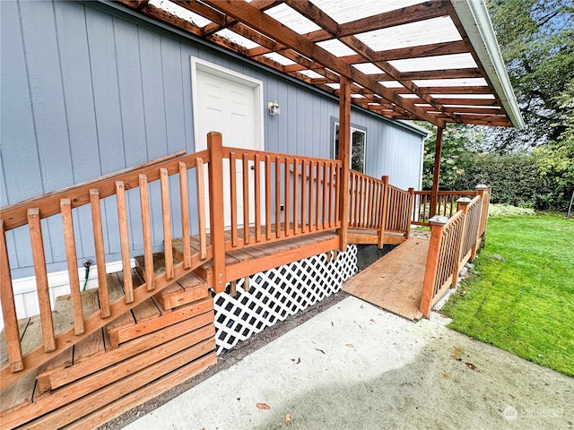 wooden terrace featuring a lawn