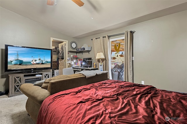 bedroom featuring a spacious closet, ceiling fan, lofted ceiling, and light carpet