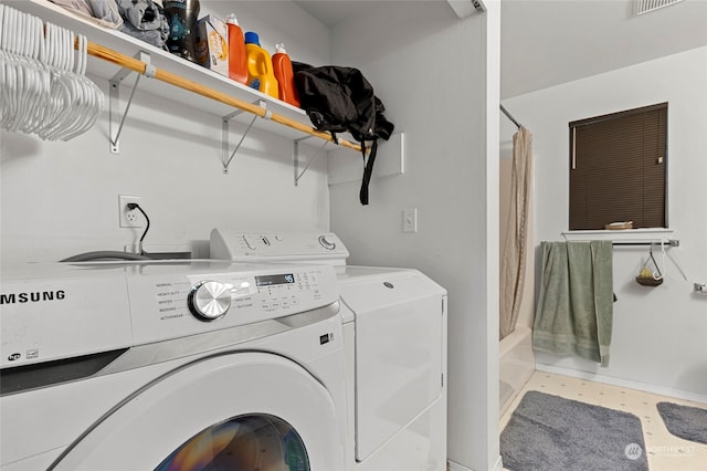 laundry room featuring washing machine and dryer