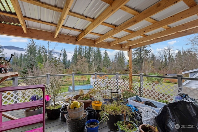 wooden deck featuring a grill