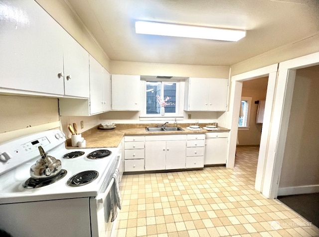 kitchen featuring white appliances, white cabinetry, and sink