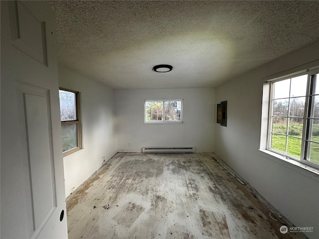 unfurnished room with light hardwood / wood-style floors, a textured ceiling, and a baseboard heating unit