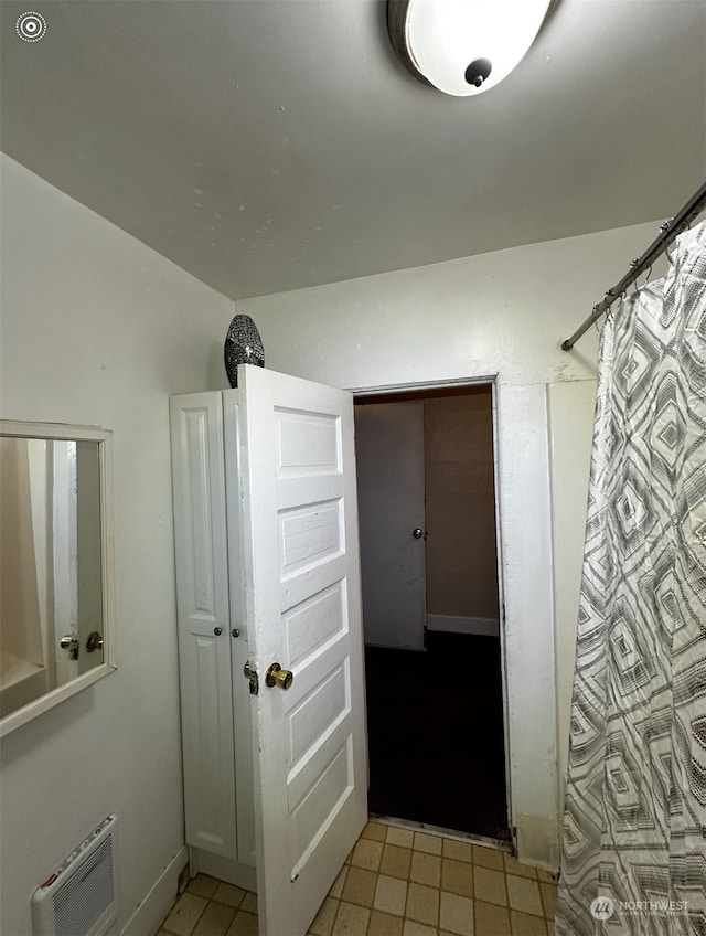 bathroom featuring vaulted ceiling and walk in shower