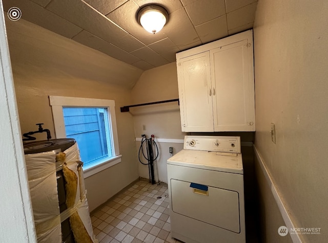 laundry area featuring cabinets, washer / clothes dryer, and light tile patterned flooring