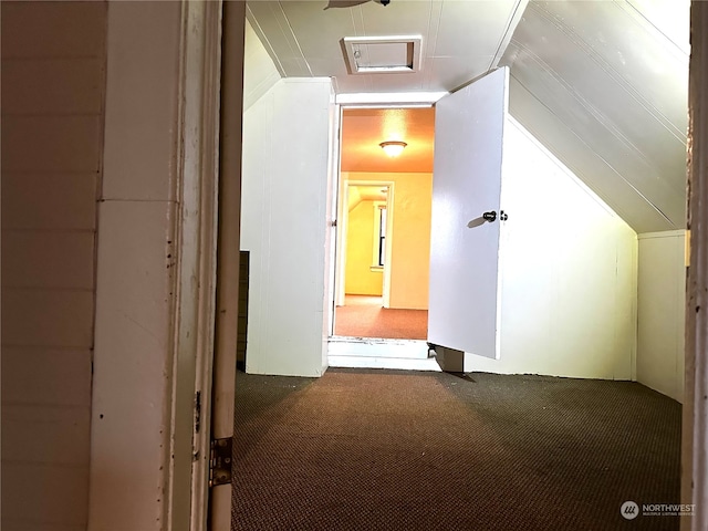 corridor with carpet and vaulted ceiling