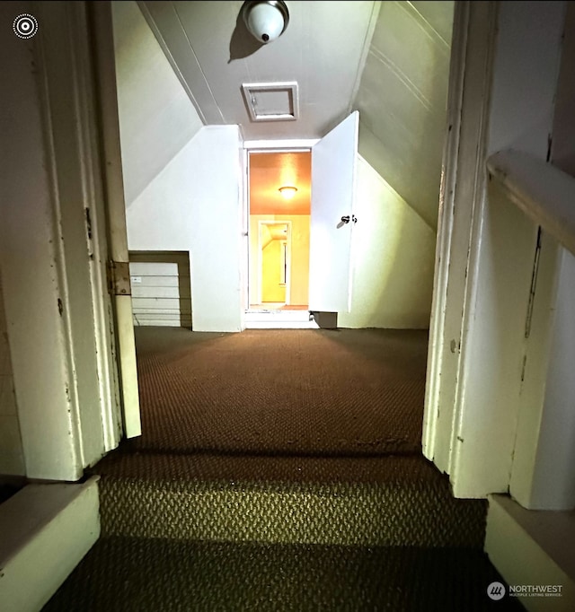 stairs featuring carpet and lofted ceiling