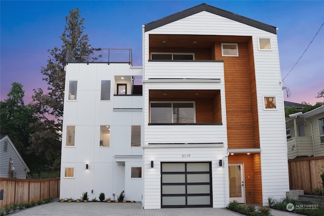 contemporary home with a balcony and a garage