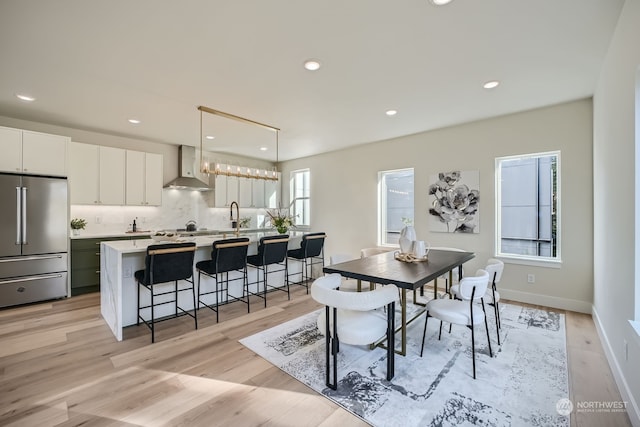 dining area featuring light hardwood / wood-style floors and sink