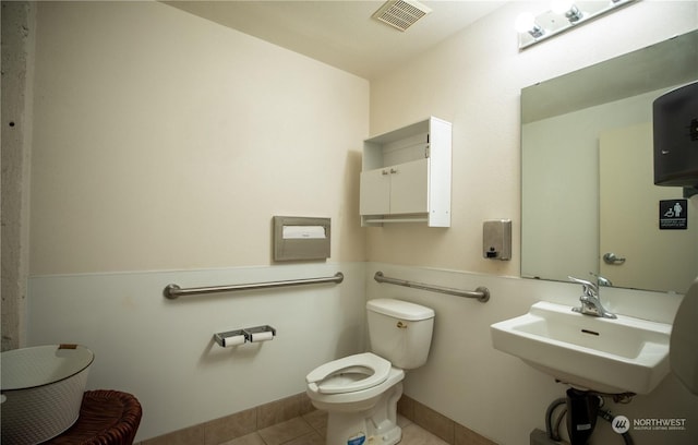 744 Market St Unit 101C, Tacoma, WA 98402 - bathroom featuring toilet, tile patterned flooring, and a sink