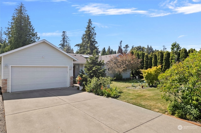 view of front of home featuring a garage and a front yard