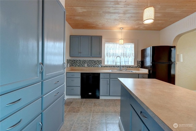 kitchen with black appliances, backsplash, pendant lighting, and sink