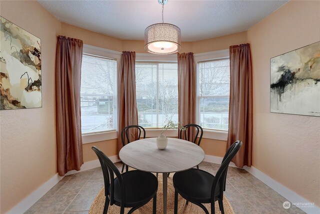 dining space featuring light tile patterned floors